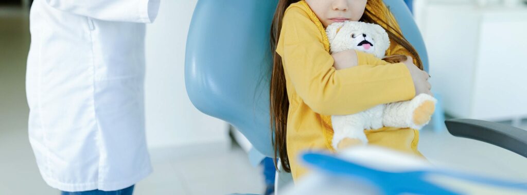 a scared kid on dental chair